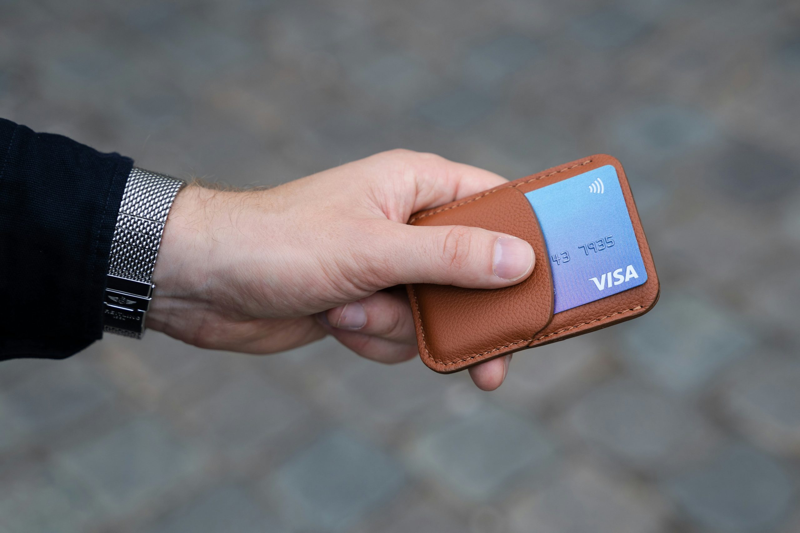 Card holder leather with man holding it.